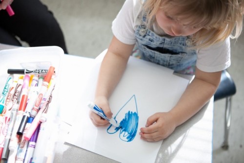 child coloring a heart